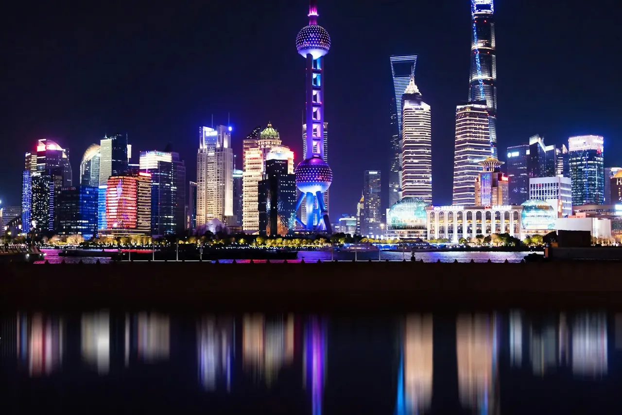 Shanghai buildings reflected in the river at night